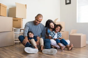 Happy Family In New Home with Moving Boxes