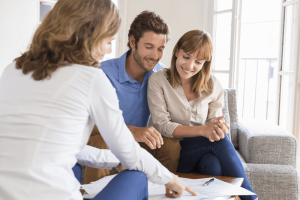 Couple reviewing paperwork with professional